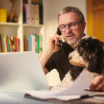 Man talking on phone in home office